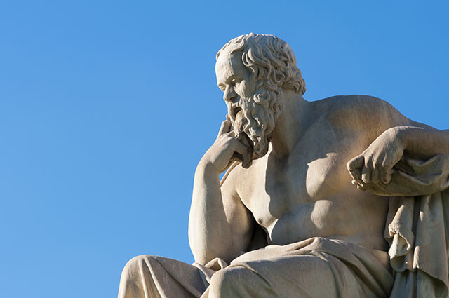 classical statue of Socrates from side, under blue sky